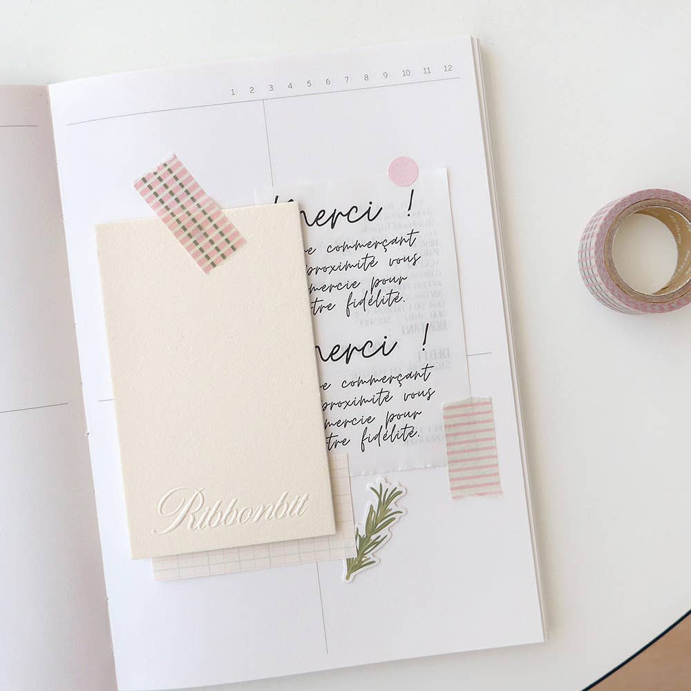 Notebook with stationery items on a white surface