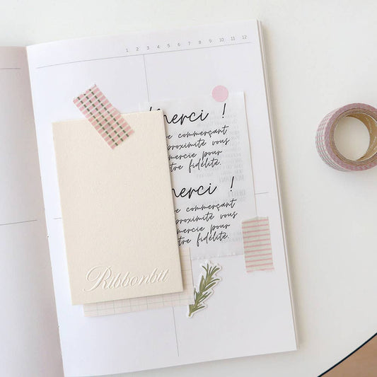 Notebook with stationery items on a white surface
